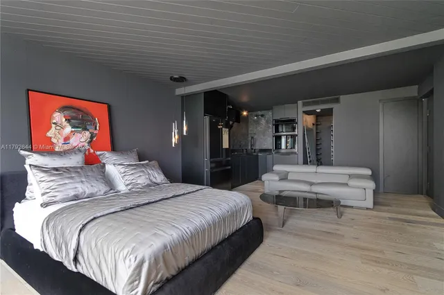 a bedroom with bed and wooden floor