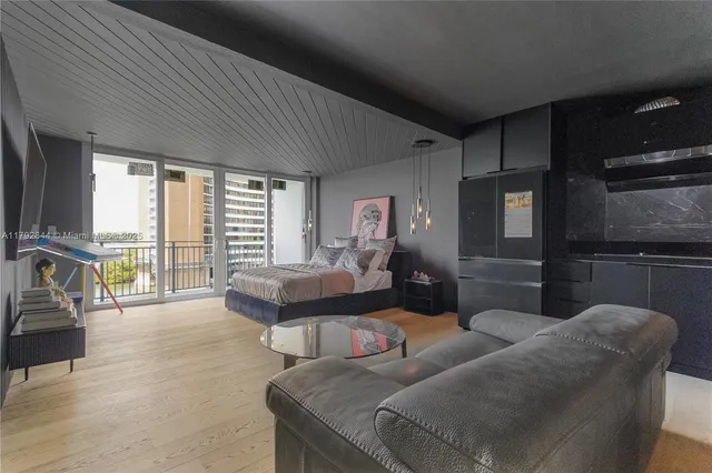 a living room with furniture and a floor to ceiling window