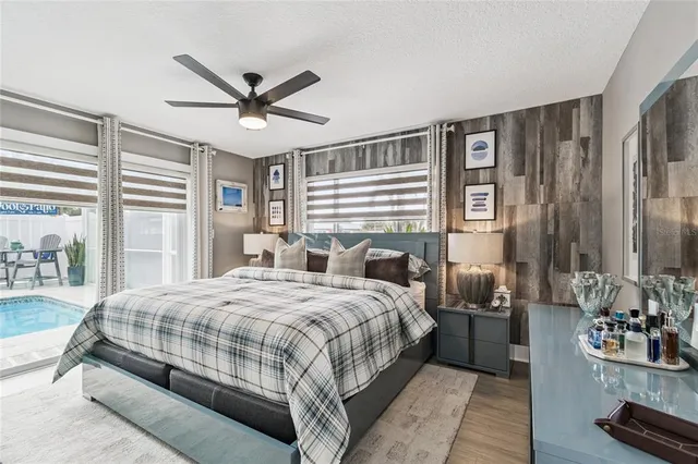 a bedroom with a bed and a large window with the outer view