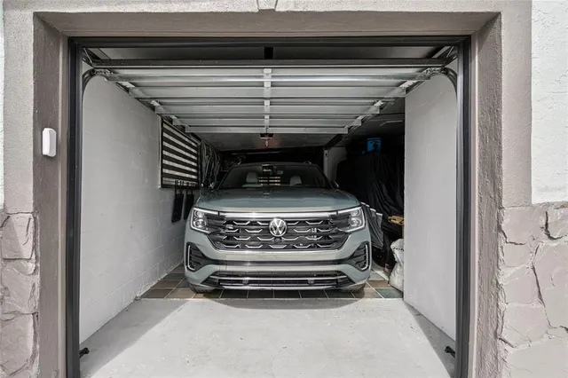a view of a house with a big yard plants and large tree