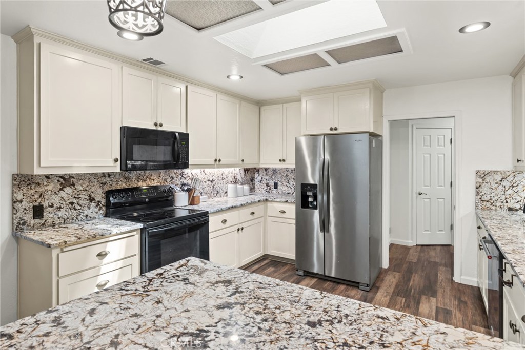 6350 Amherst Way Magalia, CA 95954 - Photo 11 of 25 a kitchen with stainless steel appliances granite countertop a refrigerator stove top oven and sink
