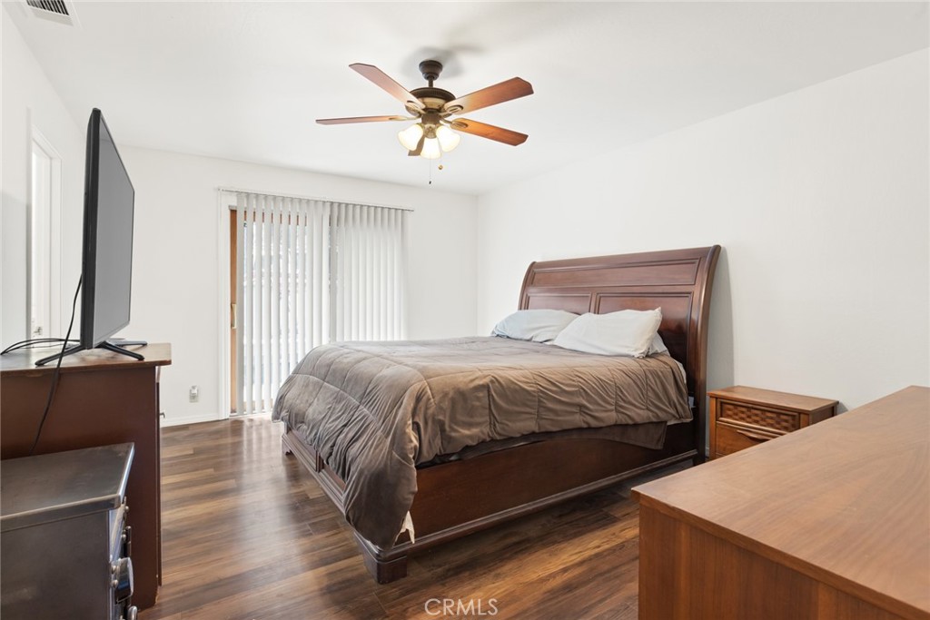 6350 Amherst Way Magalia, CA 95954 - Photo 14 of 25 a bedroom with a bed and wooden floor