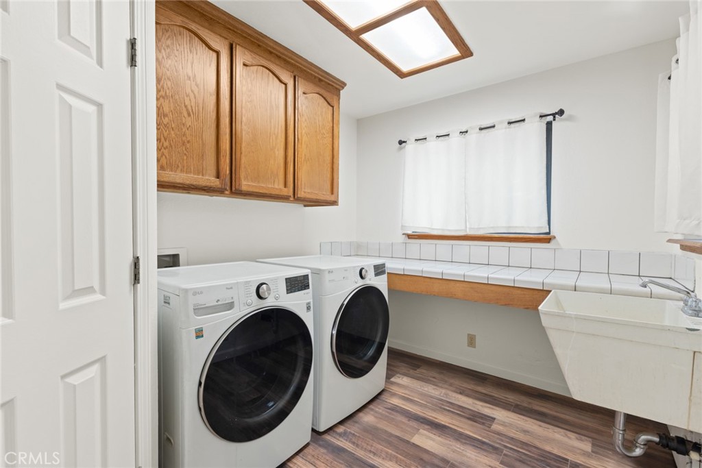 6350 Amherst Way Magalia, CA 95954 - Photo 18 of 25 a bathroom with a sink a washer and dryer next to a window
