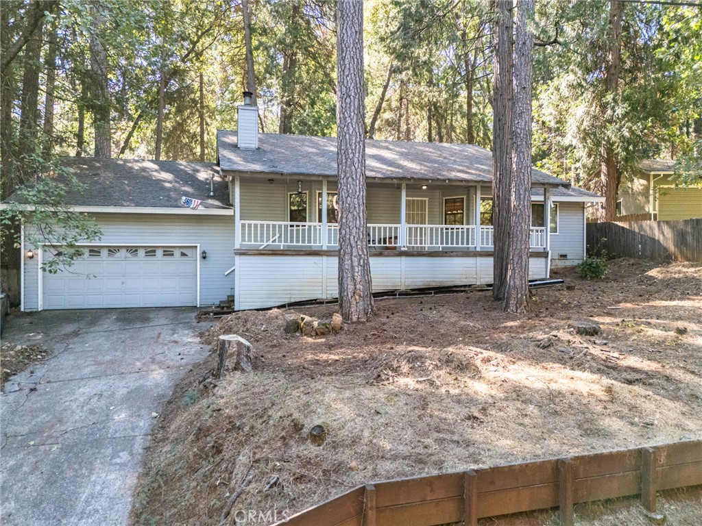 6350 Amherst Way Magalia, CA 95954 - Photo 19 of 25 a view of a house with a tree next to a yard