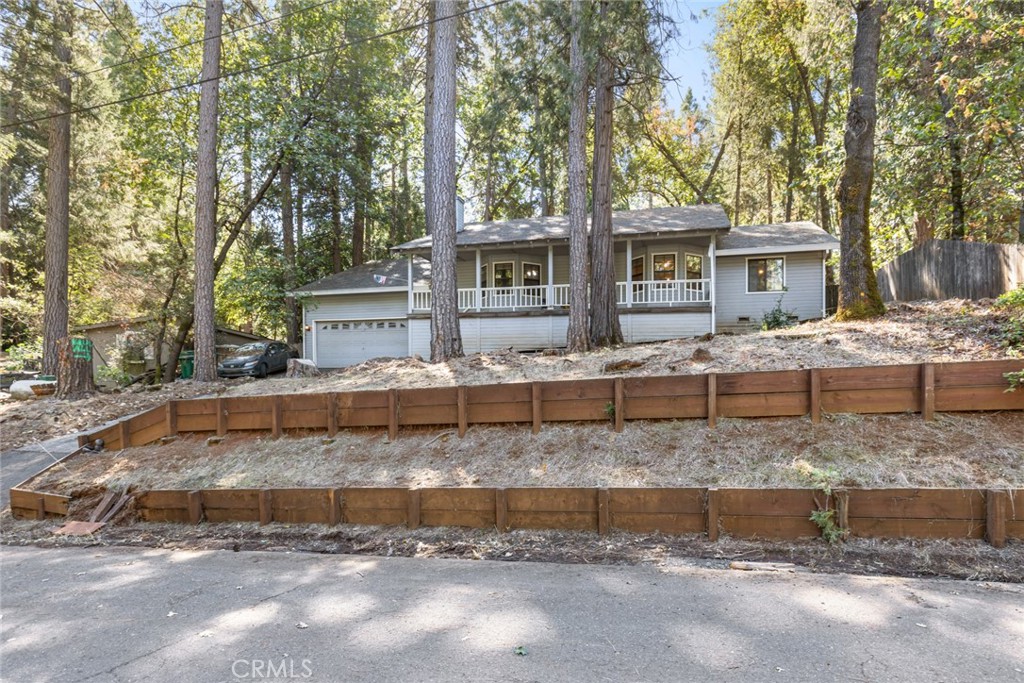 6350 Amherst Way Magalia, CA 95954 - Photo 20 of 25 a view of a house with a yard and large trees