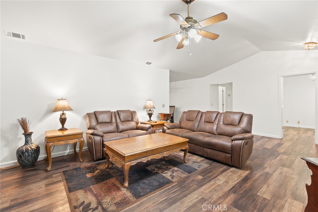 6350 Amherst Way Magalia, CA 95954 - Photo 5 of 25 a living room with furniture a chandelier and a rug