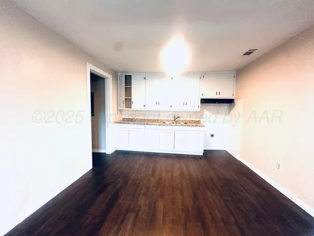 a view of kitchen with wooden floor