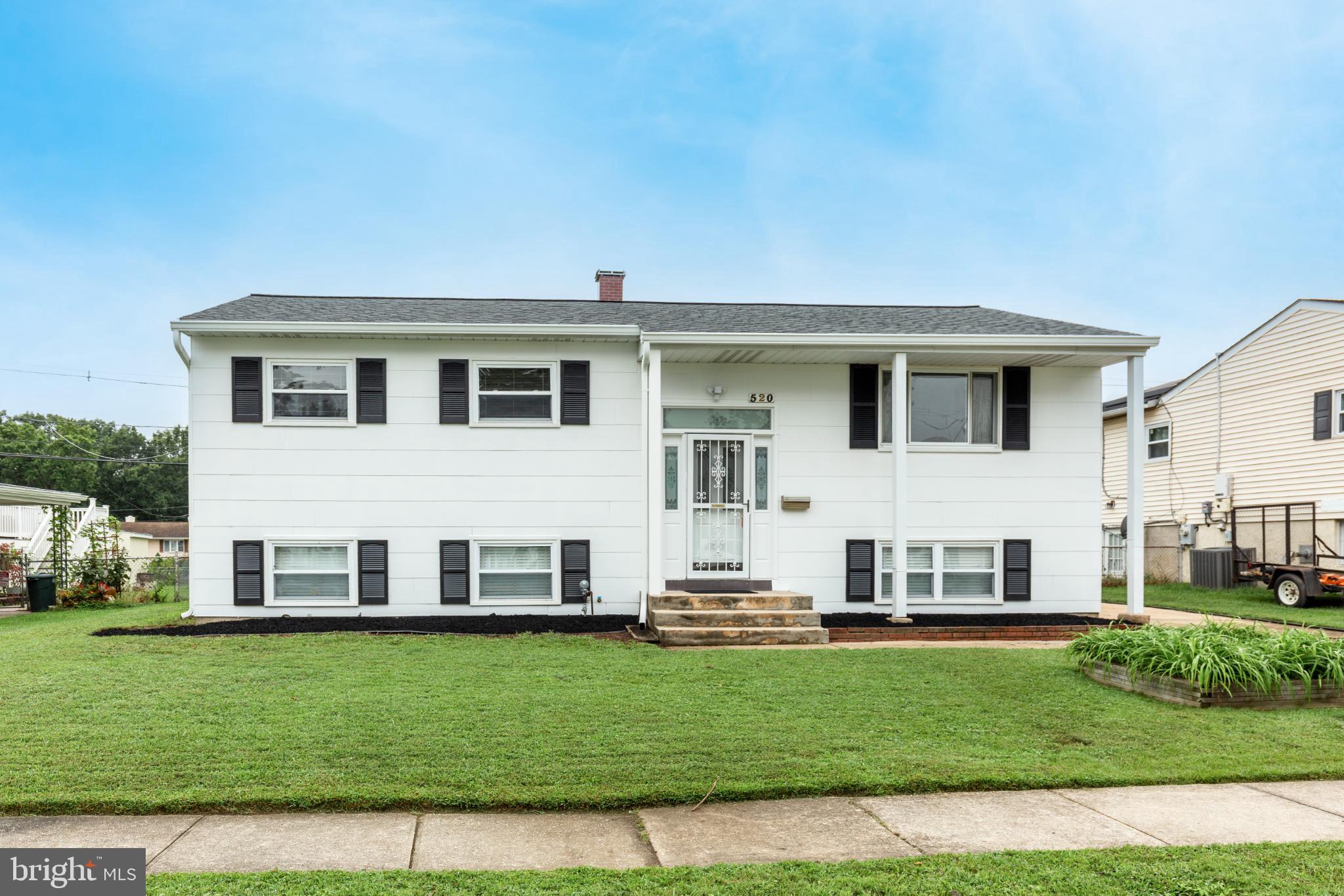 520 Crisfield Road Baltimore, MD 21220 - Photo 1 of 27 a view of a white house with a big yard and potted plants