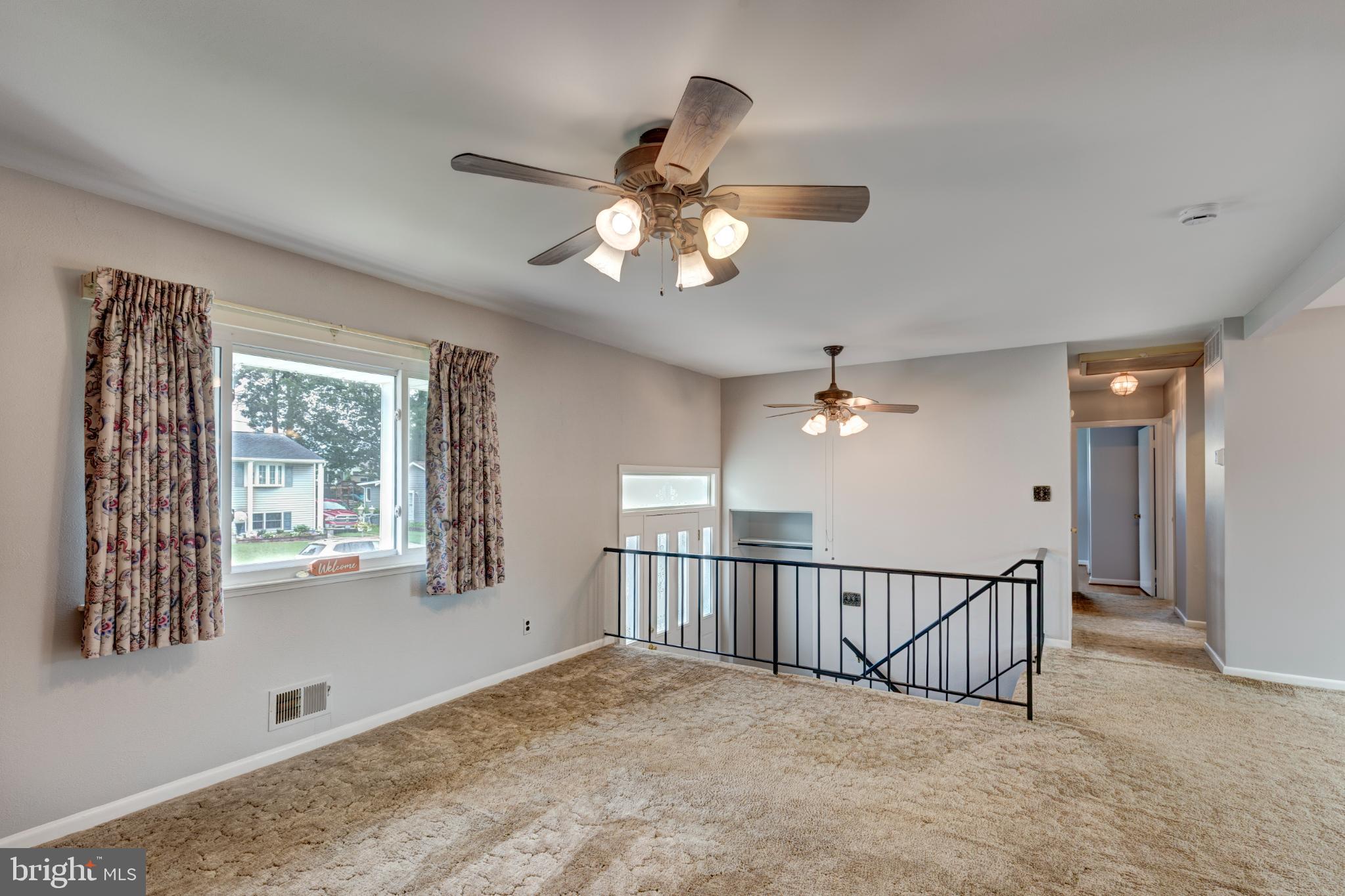 520 Crisfield Road Baltimore, MD 21220 - Photo 11 of 27 a view of a livingroom with a ceiling fan and window