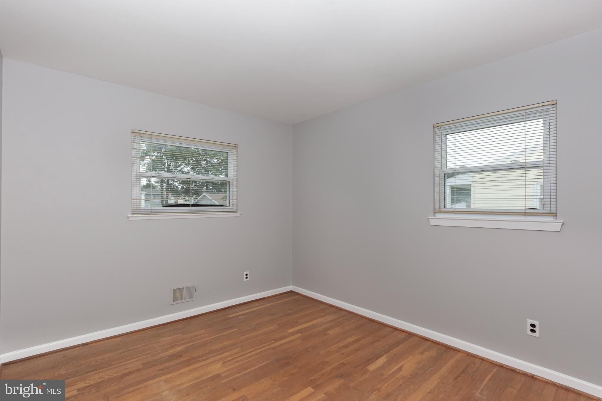 520 Crisfield Road Baltimore, MD 21220 - Photo 19 of 27 a view of an empty room with wooden floor and a window