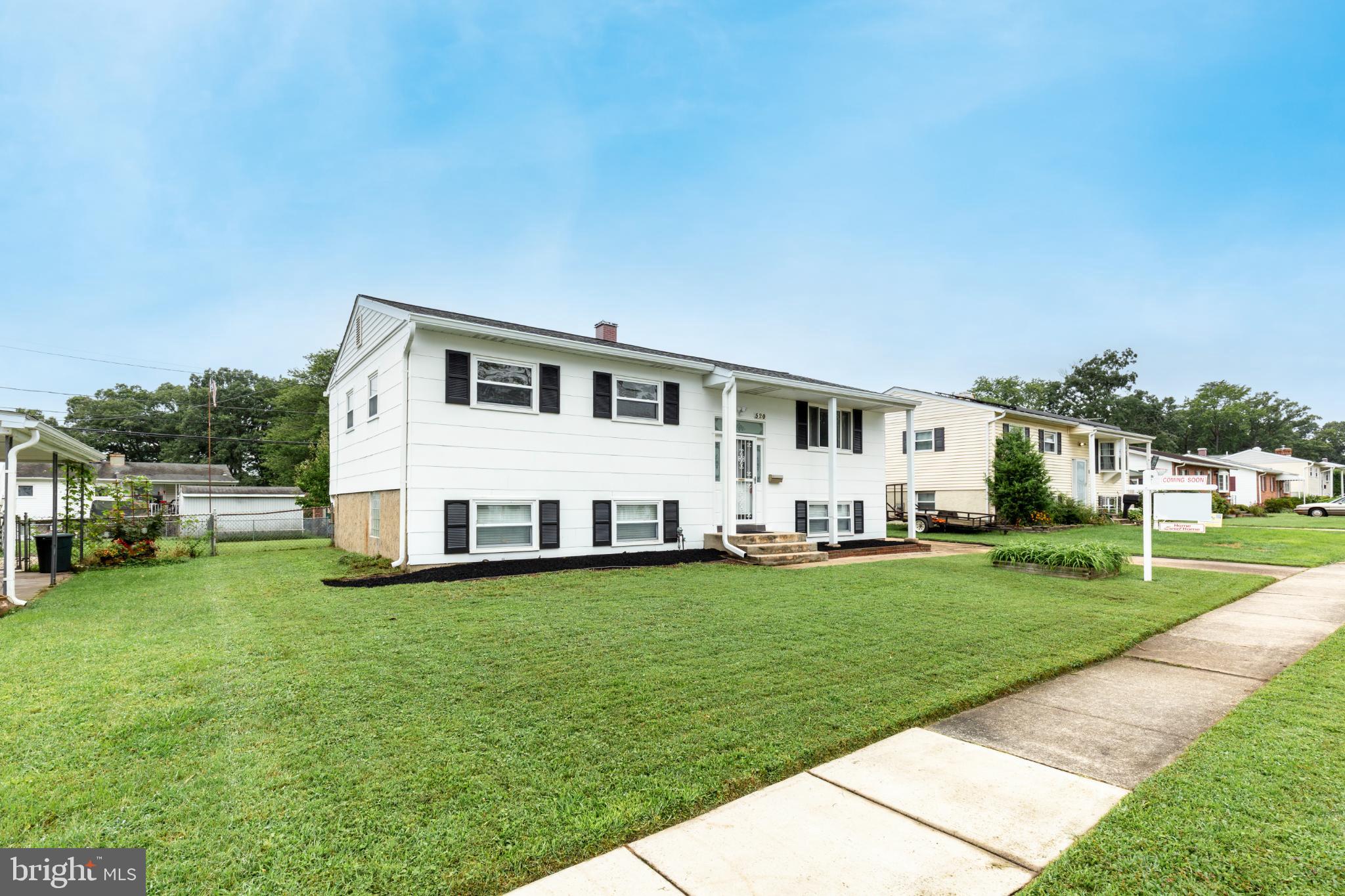 520 Crisfield Road Baltimore, MD 21220 - Photo 2 of 27 a view of a white house with a big yard and large trees