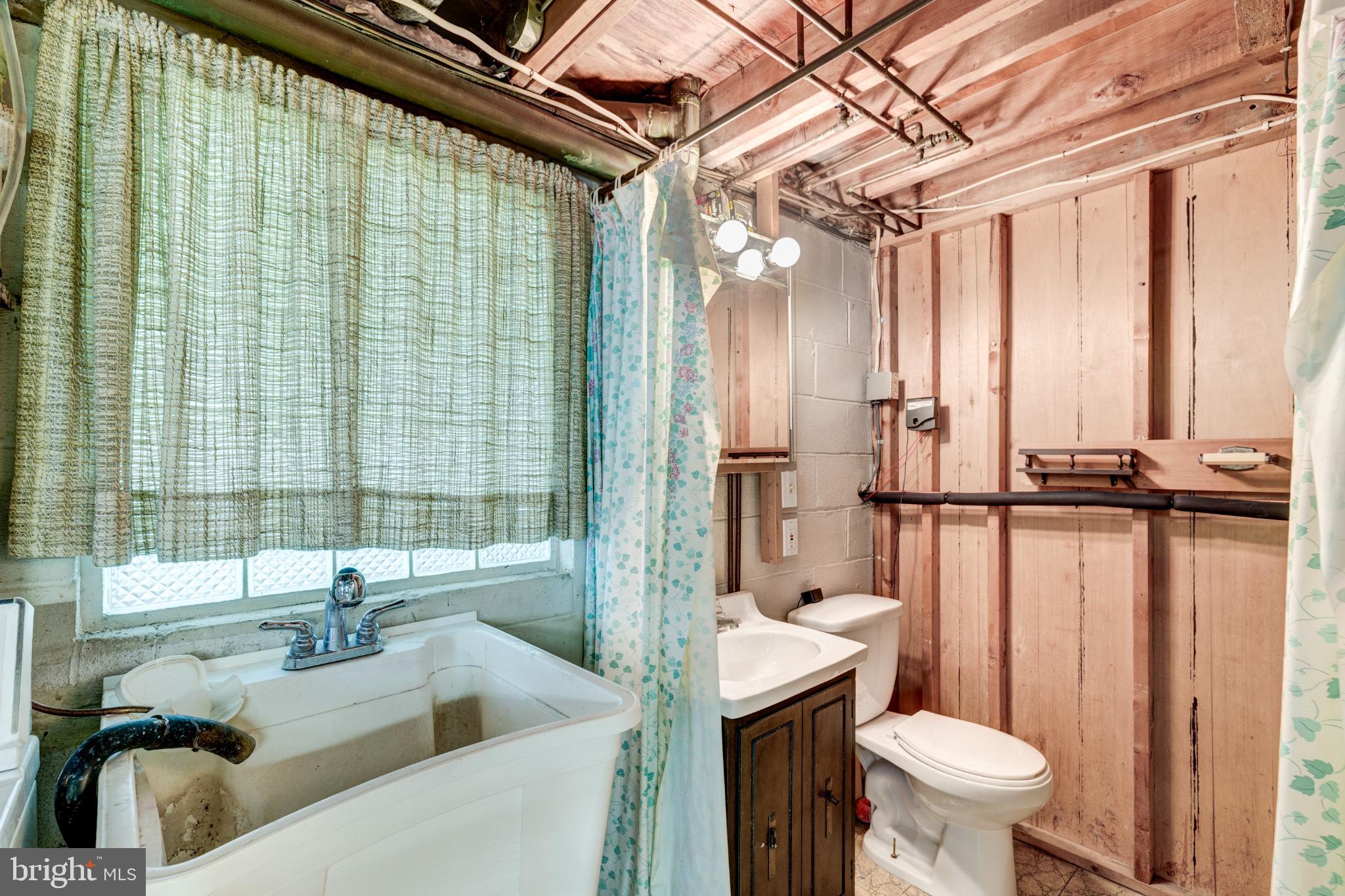 520 Crisfield Road Baltimore, MD 21220 - Photo 27 of 27 a bathroom with a sink a toilet a mirror and shower