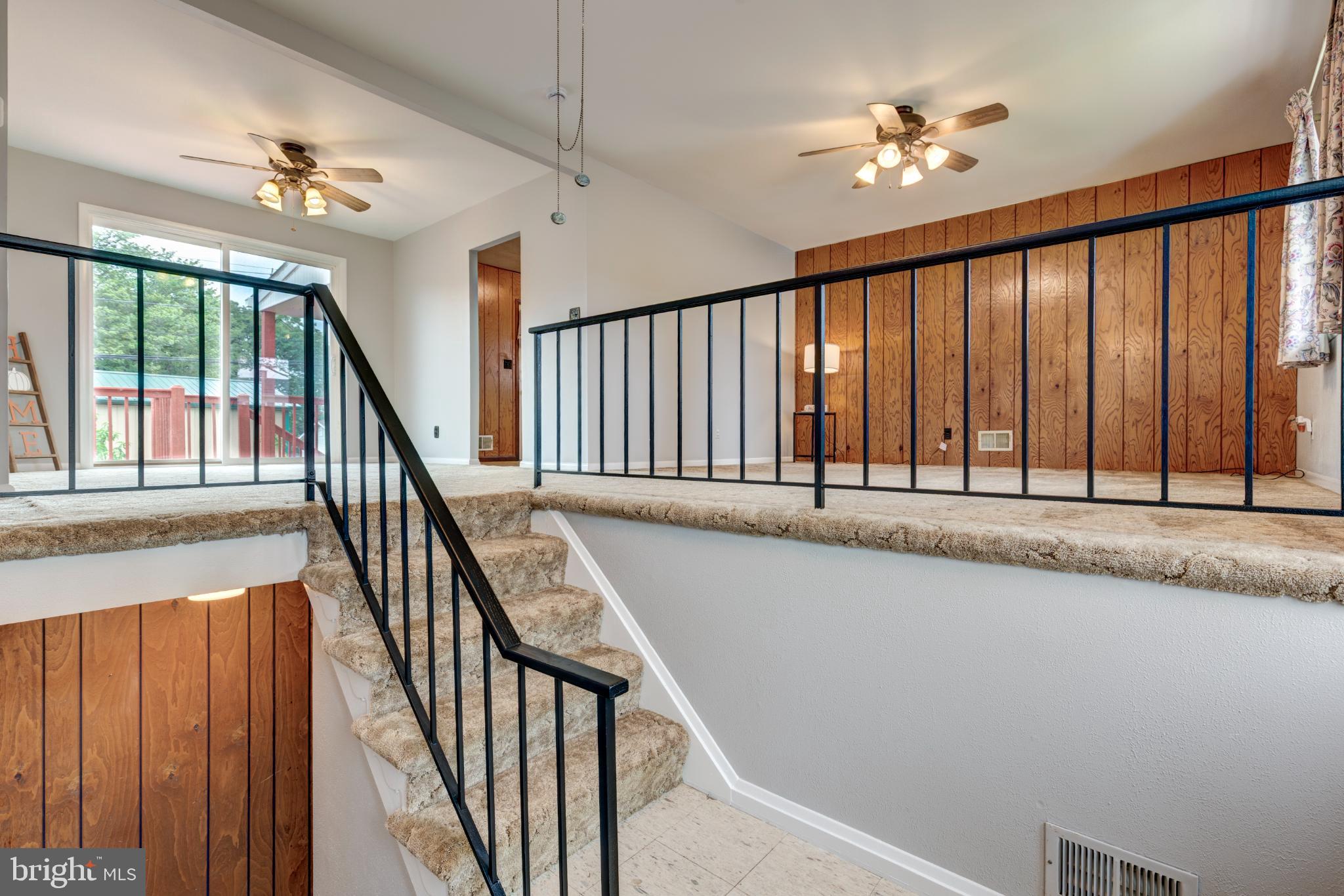 520 Crisfield Road Baltimore, MD 21220 - Photo 8 of 27 a view of staircase with railing and a chandelier