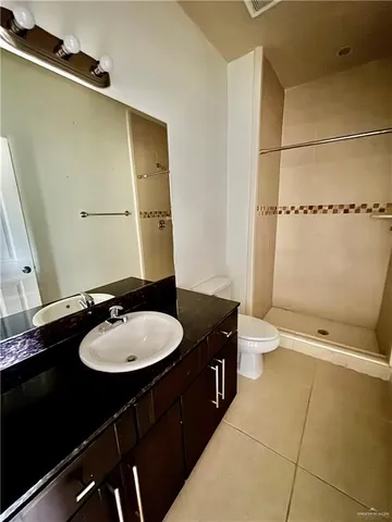 a bathroom with a sink a toilet and mirror