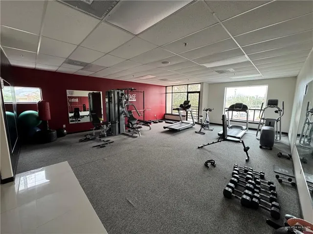 a room with gym equipment and a large window