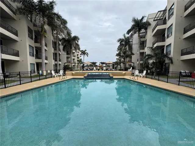 a view of swimming pool with outdoor seating and lake view
