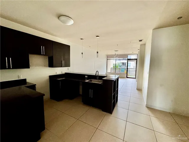 a kitchen with a sink and a refrigerator