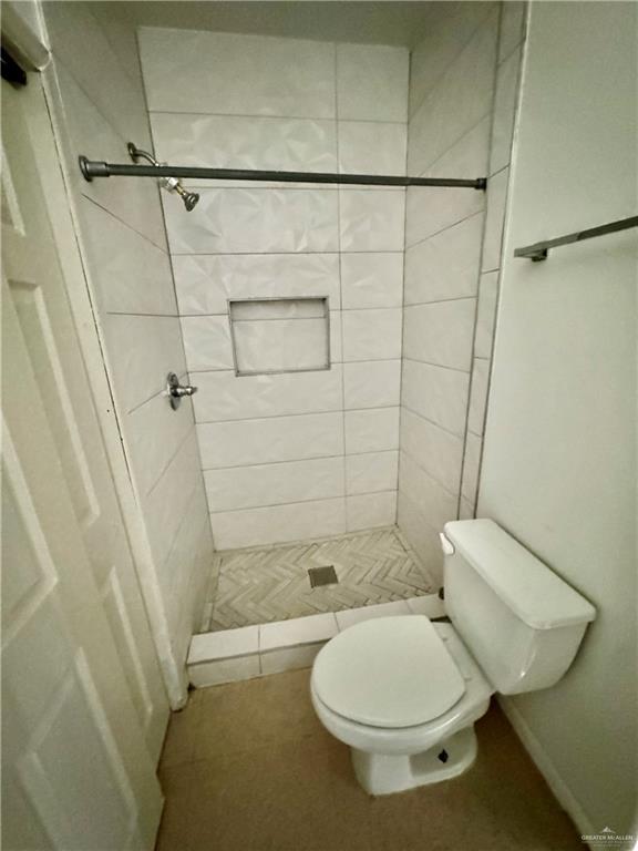 813 Travis Street, Unit 213 Mission, TX 78572 - Photo 10 of 17 a bathroom with a toilet and a shower