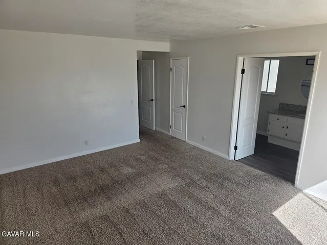 a bathroom with a granite countertop sink a mirror and shower