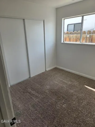 a bathroom with a granite countertop toilet sink and mirror