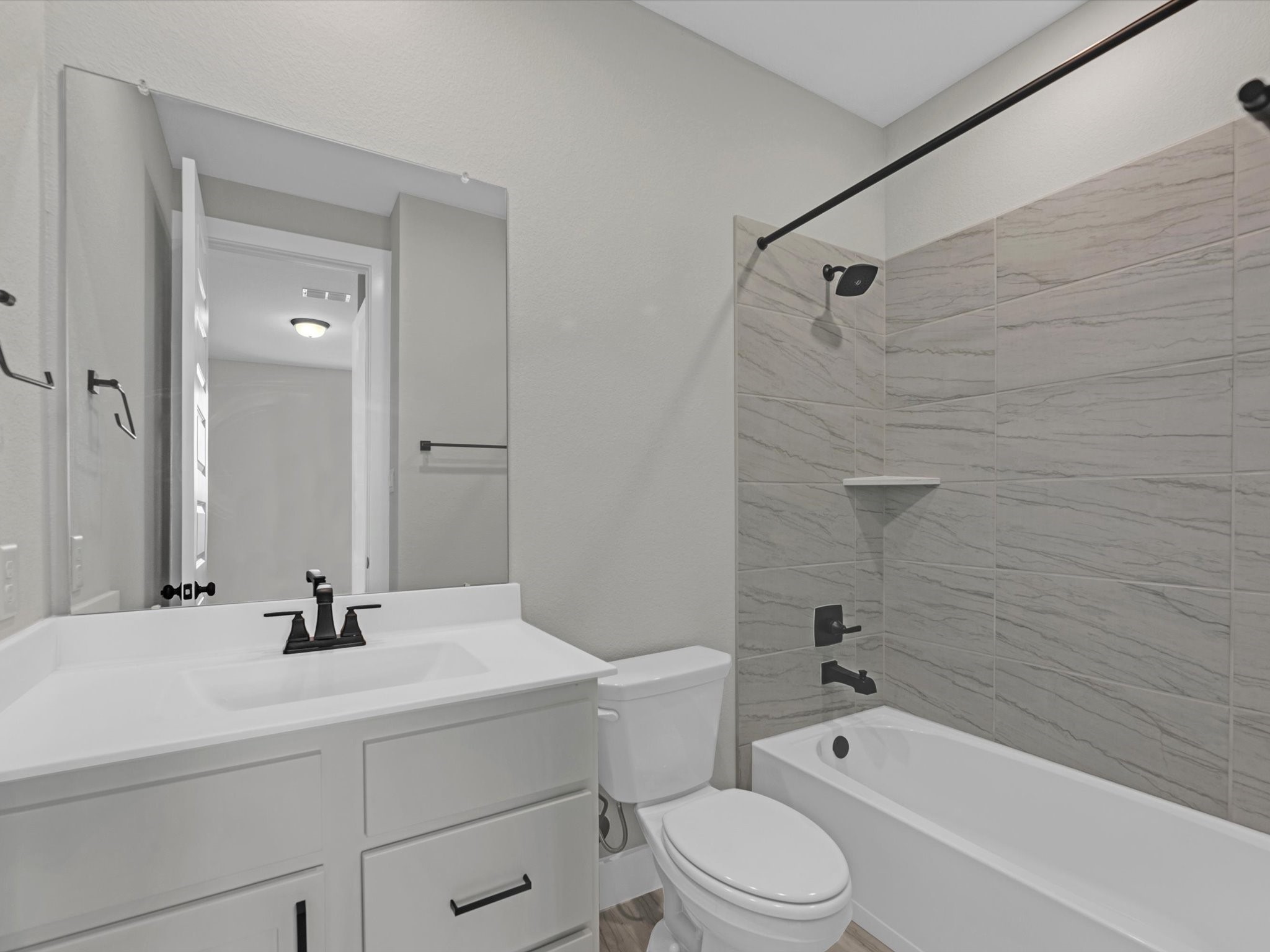 8123 Sunny Rdg Drive Fulshear, TX 77441 - Photo 16 of 42 a bathroom with a sink a toilet a mirror a bathtub and shower