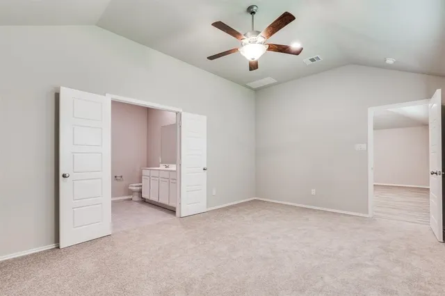 an empty room with closet and windows