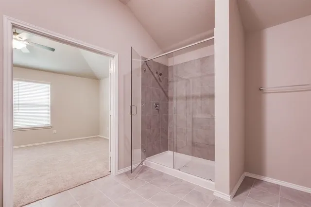 a bathroom with a glass shower door