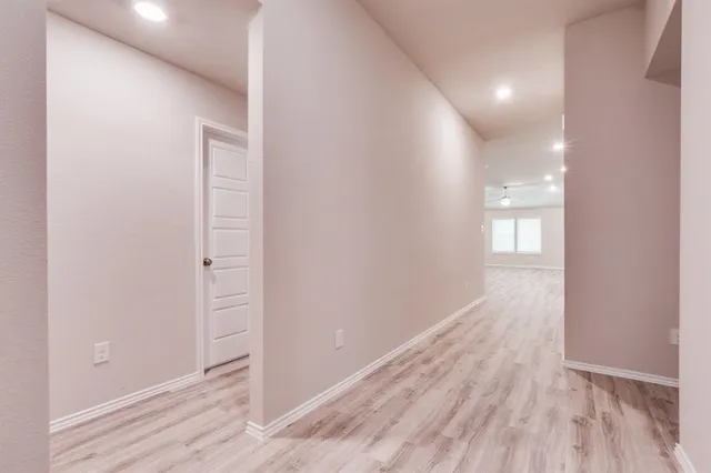 a view of hallway with wooden floor
