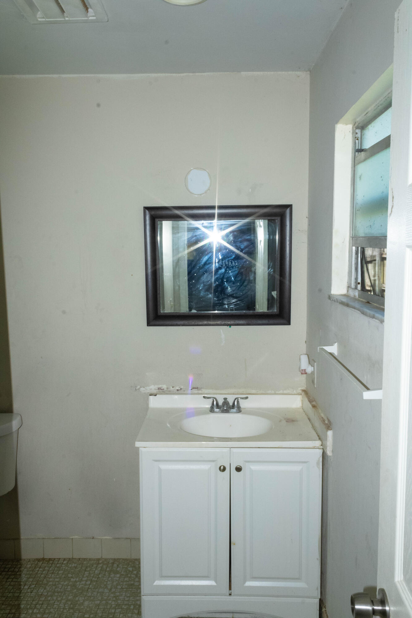 300 Manchester Street Boca Raton, FL 33487 - Photo 2 of 10 a bathroom with a sink and a mirror