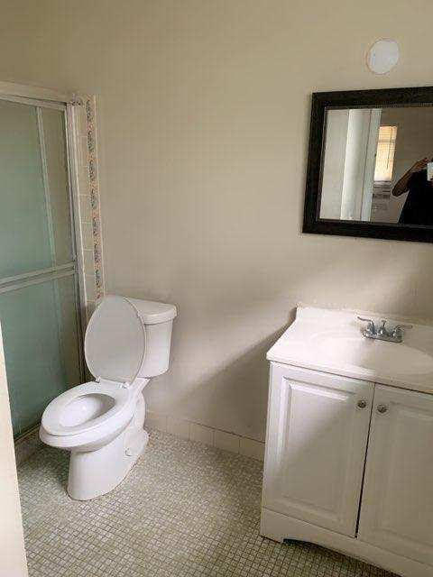 300 Manchester Street Boca Raton, FL 33487 - Photo 7 of 10 a bathroom with a toilet sink and mirror