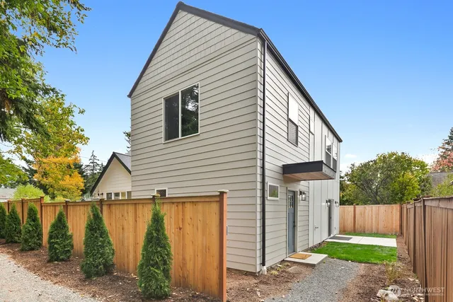 a view of a house with wooden fence