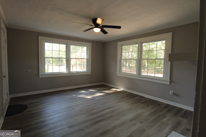 1887 Green Valley Road Griffin, GA 30224 - Photo 11 of 34 a view of an empty room with wooden floor and a window