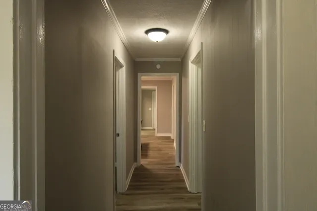 a view of a hallway with wooden floor