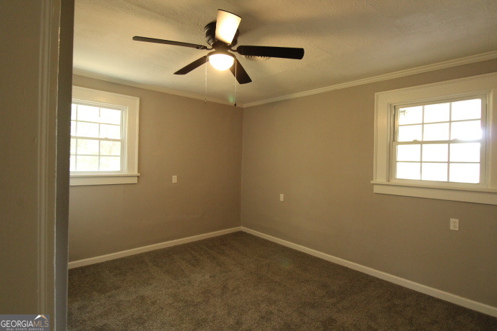 1887 Green Valley Road Griffin, GA 30224 - Photo 13 of 34 an empty room with windows and fan