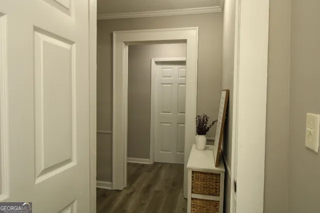 a view of hallway with wooden floor