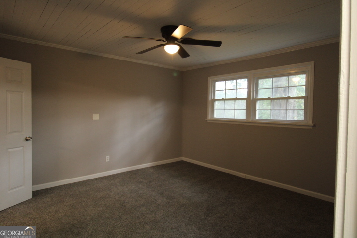 1887 Green Valley Road Griffin, GA 30224 - Photo 19 of 34 an empty room with ceiling fan and window