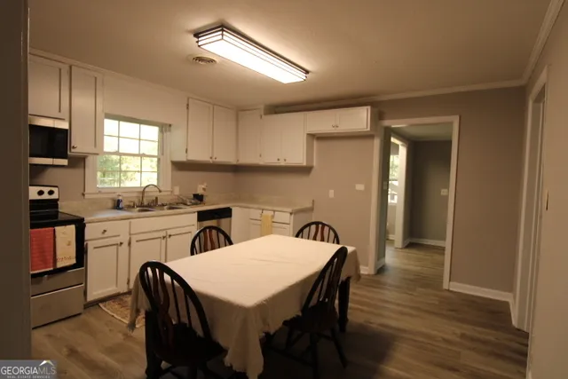 a kitchen that has a table and chairs in it