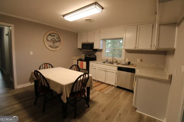 a kitchen with a table chairs and a refrigerator