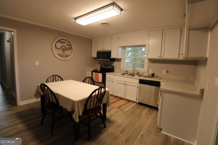 1887 Green Valley Road Griffin, GA 30224 - Photo 22 of 34 a kitchen with a table chairs and a refrigerator