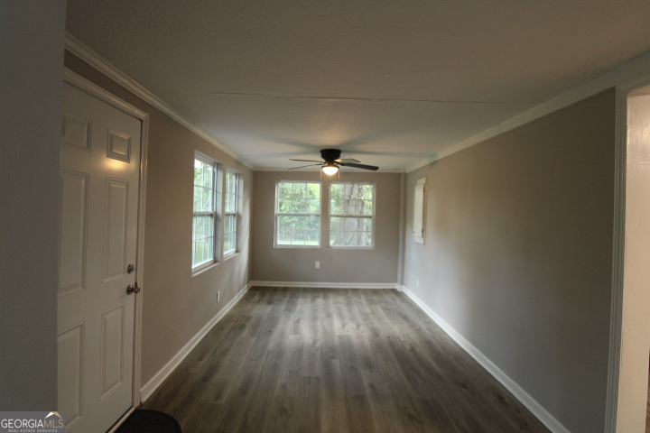 1887 Green Valley Road Griffin, GA 30224 - Photo 23 of 34 a view of an empty room with wooden floor and a window