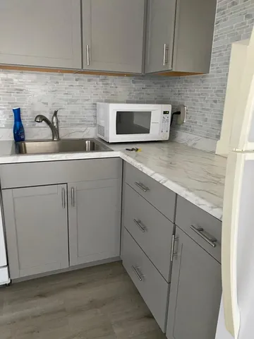 a kitchen with a sink and cabinets