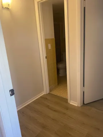 a view of hallway with wooden floor