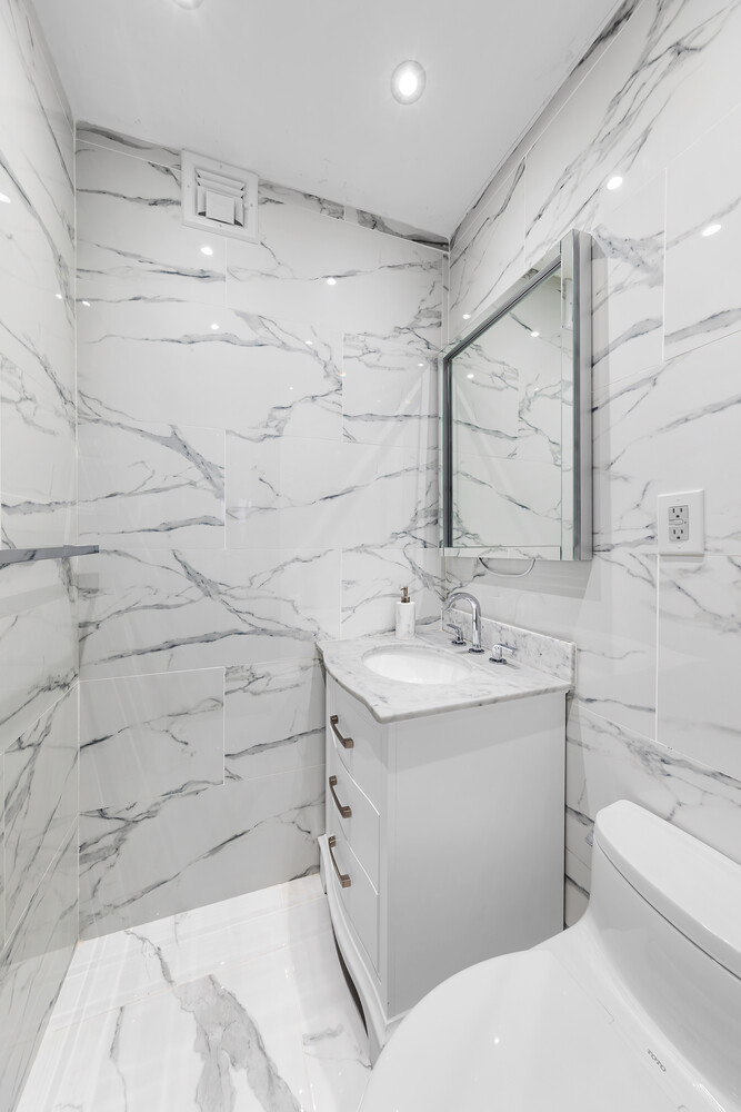 58 West 58th Street, Unit 9A Manhattan, NY 10019 - Photo 5 of 7 a bathroom with a sink and mirror