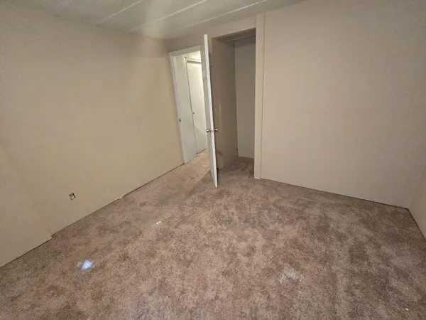 a view of an empty room and closet area