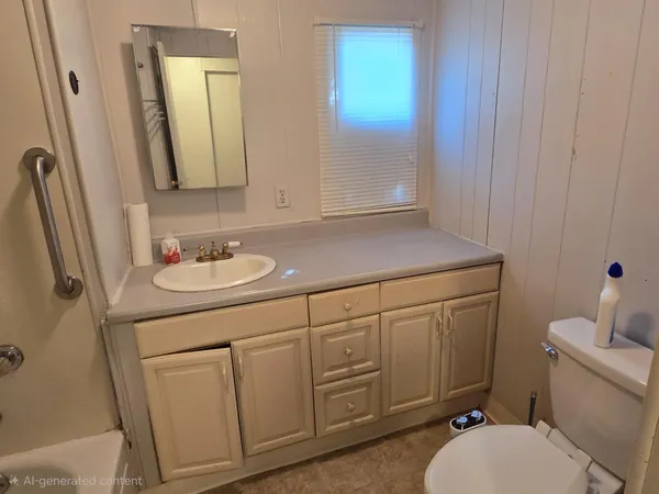 a bathroom with a sink vanity granite and toilet