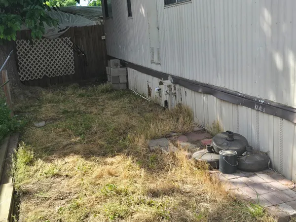 a view of a backyard with wooden fence