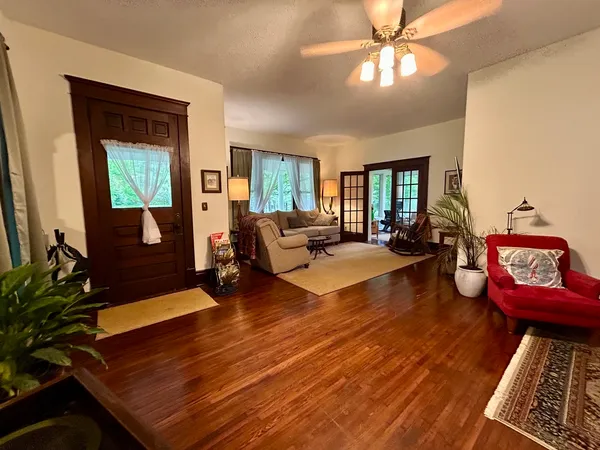 a living room with furniture and wooden floor