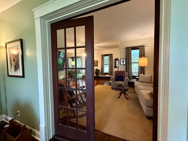 a living room with furniture and large windows