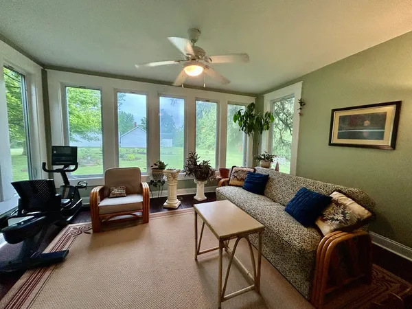 a living room with furniture and floor to ceiling windows