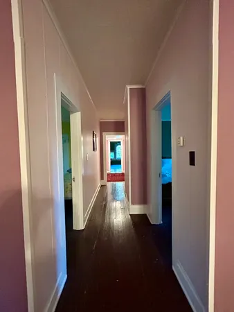 a bedroom with two beds and a chandelier